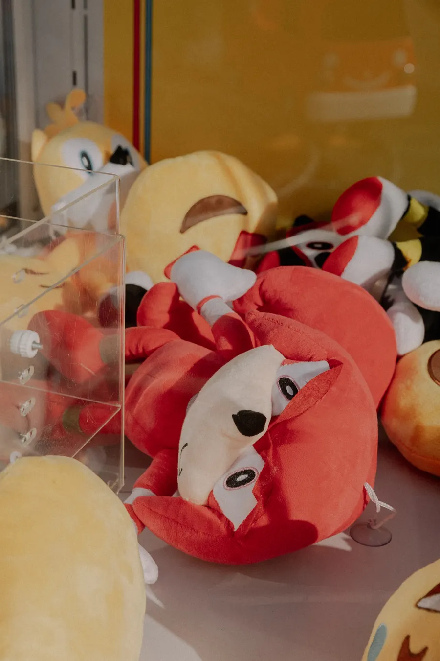 A claw machine full of colourful plush toys.